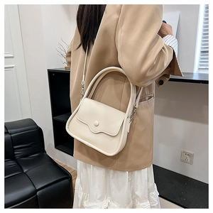 Close-up of beige lychee texture mini handbag styled with office outfit