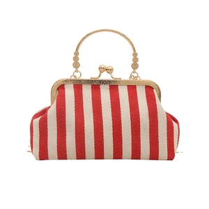 Retro red and white striped doctor bag with ornate gold metal handles and snap closure