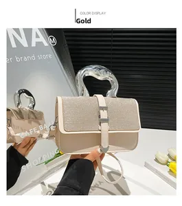 Detail of cream square handbag with rhinestone flap and silver metallic handle on mirror