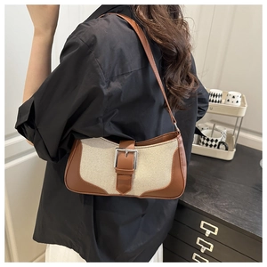 Retro patchwork underarm bag with silver buckle and shoulder strap shown on model