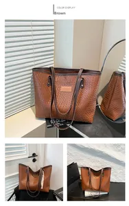 Detail of brown woven leather tote bag with brand logo in a warm home lifestyle setting