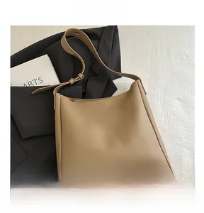 Macro view of khaki tote bag texture with adjustable strap and premium matte finish