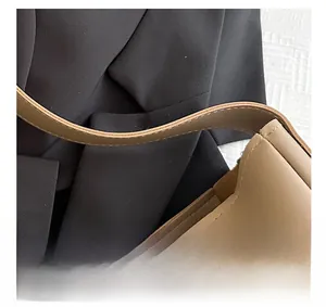 Detail of high-quality khaki leather tote bag showing refined stitching and oil-edge finish