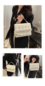 Detail of off-white quilted crossbody bag with acrylic chain and adjustable strap