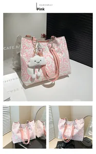 Detail of pink graffiti canvas tote with leather straps and cloud plush charm