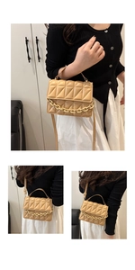 Detail of apricot quilted crossbody bag with chunky chain strap and textured leather finish