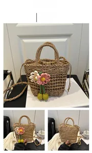 Detail of khaki woven bucket bag with handmade flower charms and drawstring lining