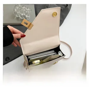 Detail view of the interior space and capacity of this cream white crossbody bag