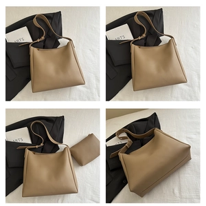Detail of khaki tote bag with adjustable strap and small matching zipper pouch