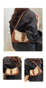 Detail view of beige canvas and brown leather stitching on a vintage shoulder bag
