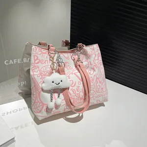 Graffiti canvas tote bag with pink straps and plush cloud charm for school and commute