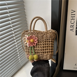Handmade straw woven beach bag with floral charms and cherry pendants for summer holidays