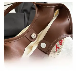 Detailed macro view of woven tote with dual magnetic snap closures and leather trim