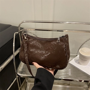 Deep brown snakeskin textured underarm bag with silver hardware and adjustable strap
