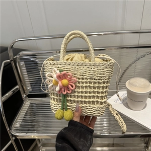 Handmade cream woven straw handbag with floral crochet accents for summer beach beachwear