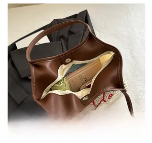 Detailed top view of a woven tote bag showing spacious interior and magnetic closure