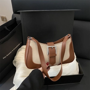 Minimalist crescent shoulder bag in brown leather and beige canvas with silver buckle