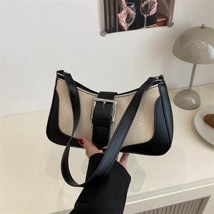 Minimalist ivory woven crescent bag with black leather trim and silver metal buckle