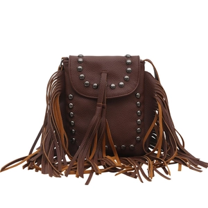 Vintage brown leather crossbody bag featuring bohemian fringe and metal rivet details