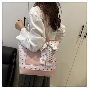 Detailed side view of pink quilted tote bag with rabbit print and silk scarf decor