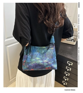 Close-up of artistic Monet style water lily embroidery on a blue purple bucket bag