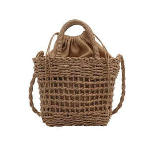 Handmade hollow straw crossbody bag with drawstring liner for summer beach vacation