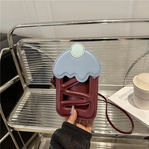 Chic cupcake-shaped crossbody bag in burgundy and blue leather with wavy icing detail