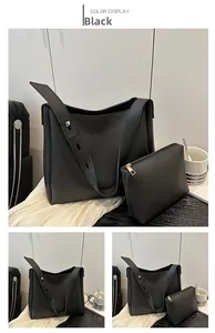Detail view of the black matte leather tote bag set including a small pouch and wide strap