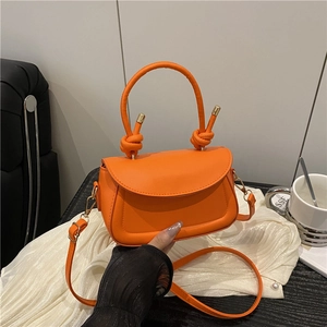 Fashionable orange top handle bag with knotted handle and crossbody strap for women