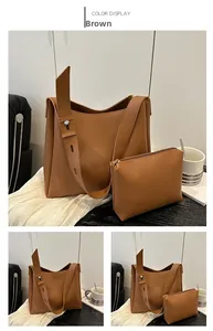 Detail of dark brown leather tote bag set with wide shoulder strap and matching pouch