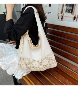 White canvas tote bag featuring floral lace detailing and a decorative lace bow strap