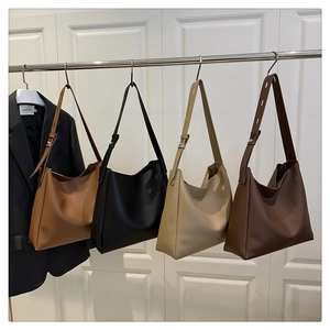 Detail showing minimalist tote bags in beige, caramel, brown and black matte finish