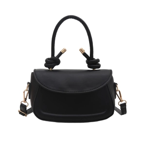 Minimalist black top handle crossbody bag with decorative knotted strap and gold hardware
