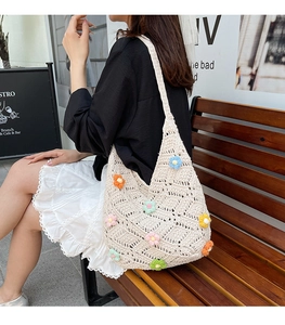 Detail of hand-woven hobo bag with colorful floral crochet and mesh texture