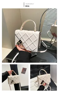 Detail of white quilted crossbody bag with gold chain and metal buckle closure