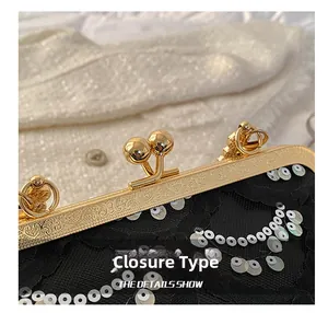 Close-up of golden metal kiss lock with intricate patterns and shiny silver sequins