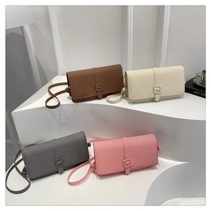 Four elegant crossbody bags in diverse colors displayed on modern geometric pedestals