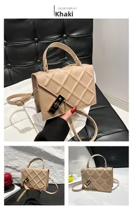 Detailed close-up of khaki quilted crossbody bag featuring metal lock and short chain