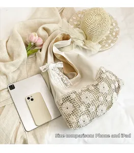 Cream hollow-out floral canvas shoulder bag with iPad and phone for size comparison