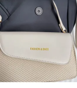 Detail of raffia and cream leather small crossbody bag with gold fashion lettering