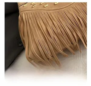 Detail view of khaki suede fringe bag with rows of polished golden metal rivets