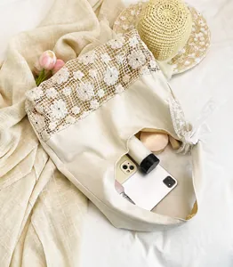 Close-up of hollow crochet flower lace on a beige canvas shoulder bag