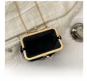 Close-up of a black sequin dinner bag showing interior space and gold chain strap