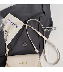 Detail of crossbody bag with woven texture, leather flap and adjustable strap