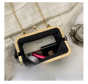 Detail showing internal capacity of the black sequin evening bag with gold chain