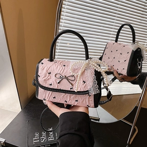 Pink pleated handbag with black bow prints and silver buckle for summer fashion style