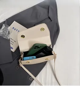 Interior view of cream shoulder bag showing large capacity for phone and cosmetics