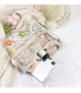 Interior detail of a floral crochet shoulder bag showing spacious storage for iPad and phone