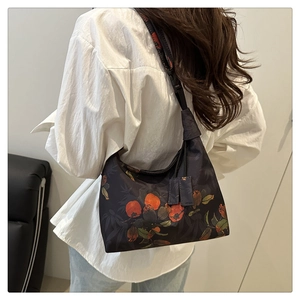 Detail of Chinese style embroidery bucket bag with orange persimmon pattern on dark canvas