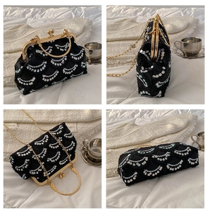 Macro shot of elegant black sequin evening bag with gold metal frame and chain